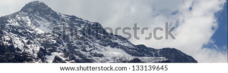 beautiful snow mountain with clouds and fog - Jade Dragon Snow Mountain or Mount Yulong in Lijiang, Yunnan province