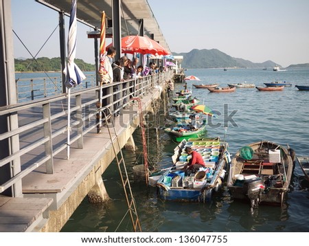 HONG KONG - OCTOBER 29: The boatmen trade with the tourists in Sai Kung on Oct 29 2010. Sai Kung is a typhoon shelter, where motorized junks used in the local tourist trade now are moored.