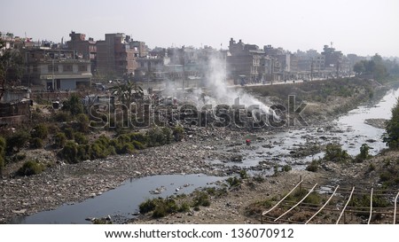KATHMANDU, NEPAL - JANUARY 20: residents burn rubble near the river in kathmandu suburb on 20 jan 2010. the United Nations list Nepal as one of the Least developed country in the world