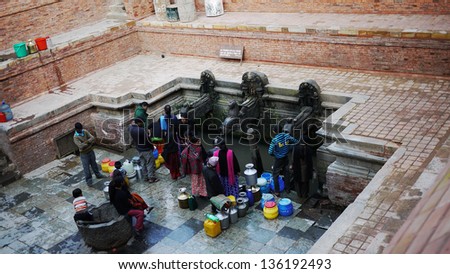 BHAKTAPUR, NEPAL - JANUARY 29: residents wait for water in BHAKTAPUR on 29 Jan 2010. Tap water is unavailable in this town, the United Nations list Nepal as one of the Least developed country