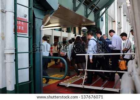 HONG KONG - APRIL 24: The passengers go from ferry to pier on April 24, 2013 in Hong kong. Its principal routes carry passengers across Victoria Harbor, one of the tourist attraction in Hong Kong