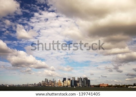 NEW YORK, CIRCA:the skyline of Manhattan under the cloudy sky with the long distance view from ferry in New York CIRCA. it is the heart zone of new york city
