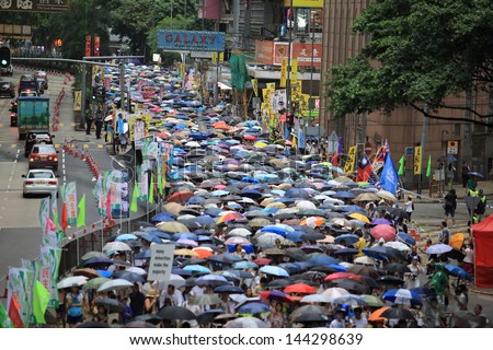 HONG KONG - JULY 1: The umbrellas river in Hong Kong 1 July protests in Hong Kong on 1 July 2013. the protesters request the  political reform, the economic crisis and the solution of housing problem