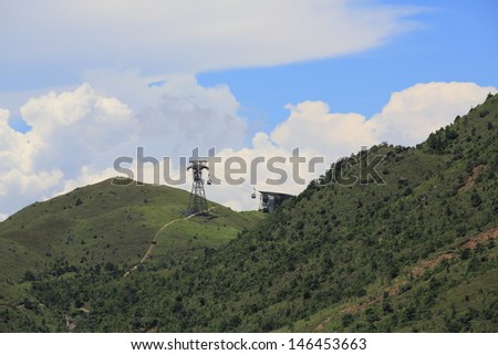 Ngong Ping 360 cable car tower with the cloudy landscape from Lantau Island in beautiful summer landscape