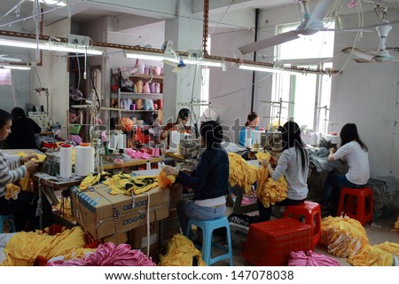 Puning,China-March 17:Unidentified Labors Work In Family Business Clothing Workshop In Canton On March 17 2013. China Manufacturing Trend To Move From Coastal To Inland Area Because The Cost Is Growth