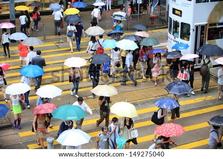 HONG KONG, JULY 26: the pedestrians walk through the road at Central in Hong Kong on 26 july 2013.7 p.m. is the peak of rushing hour in central because all people come off work
