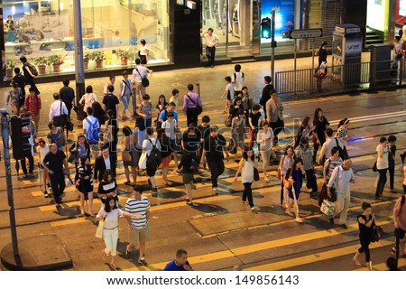 HONG KONG, JULY 26: the pedestrians walk through the road at Central in Hong Kong on 26 july 2013.7 p.m. is the peak of rushing hour in central because all people come off work