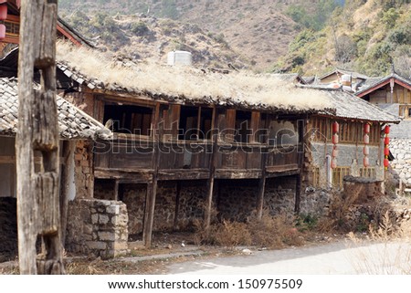 LIJIANG, CHINA -FEB 18: old buildings remain in Lijiang old town on Feb 18 2012.Under china economic growth, rural area and old town develop the tourism industry but culture invasion also occupied