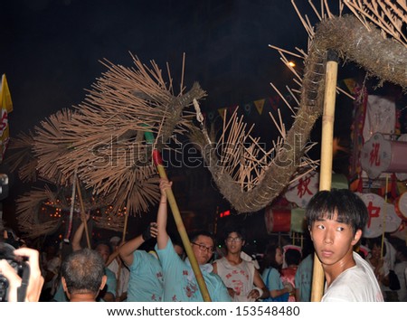 HONG KONG, SEPTEMBER 20: dragon dancing in Hong Kong Tai Hang Fire Dragon Dance in Tai Hang on 20 sept 2012. every years villagers stage a fire dance to stop a plague wreaked havoc and pray the god