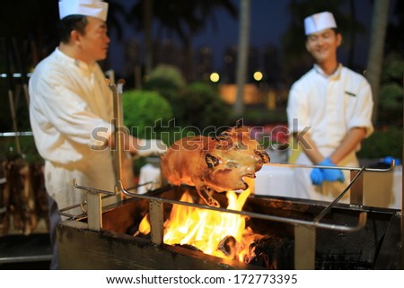 HONG KONG, JANUARY 15: roast suckling pig is cooked in hong kong on 15 january 2014. It is a popular dish at wedding dinners or a party for a baby's completion of its first month of life