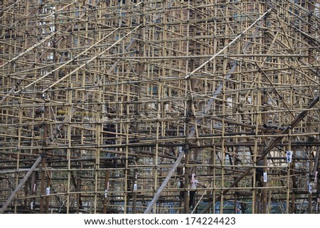 worker hide in the bamboo scaffolding for chinese opera stage