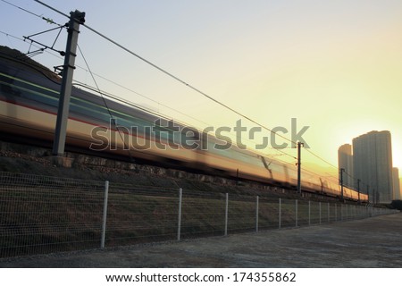 Good Morning :  under the bright, first train running / speed up on railway in hong kong, china, Tung Chung area, Lantau Island cityscape