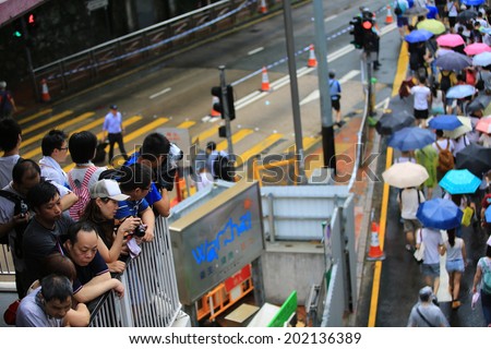 HONG KONG,JULY 1: Photographers take photo in the protest in hong kong on 1 July 2014. People protest for urban development, housing issue, and mainland china policy to hong kong,