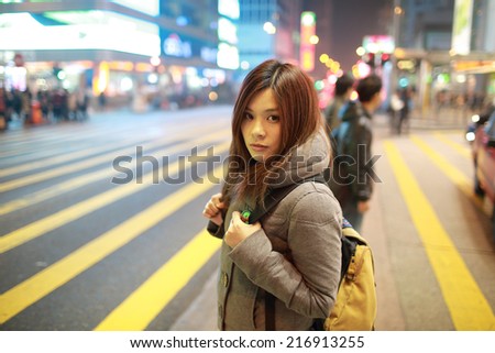 travel girl lost in city, standing in the road