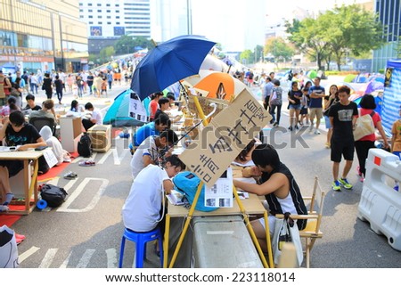 HONG KONG,OCT. 13:students study on the street while ocuppy protest is insisted in Admiralty on 13 october 2014. People involved revolution after two week, they leave comment and the symbol Umbrella