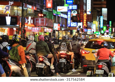 TAICHUNG;TAIWAN,APRIL 12: People and riders are busy on the street in Fengjia Night Market on 12 april 2015. Fengjia Night Market is one of the famous night market in Taiwan