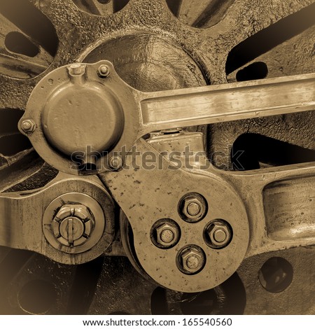 Axle and connecting rods of a steam train wheel mechanism. Vintage sepia effect. Square format.