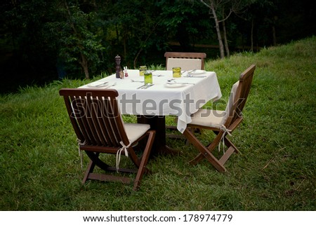 A dinner setting for three outdoors in Uganda.