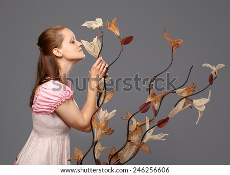 Portrait of a beautiful woman smelling a flower