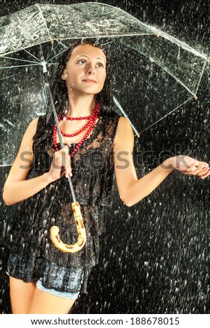 Happy girl with rain and transparent umbrella