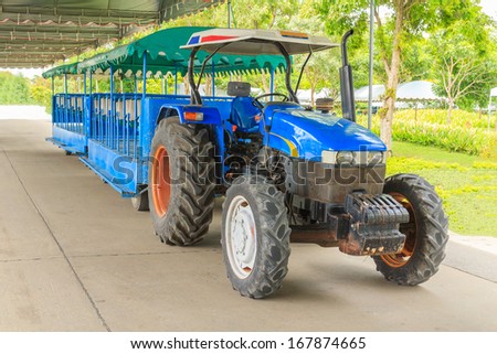 Tractor for transportation in the garden public.