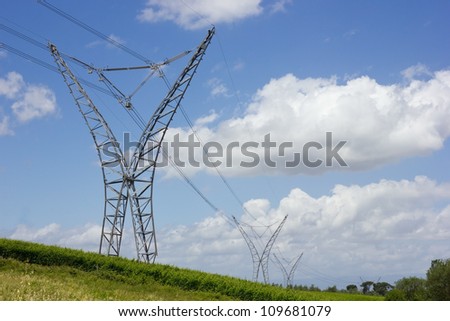 long lines of power-line towers stretching across a countryside