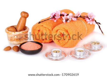 Spa and wellness setting with flowers, candle and towels isolated