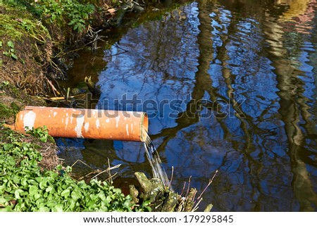 Industrial Pipe Dumping Waste Water Into The river