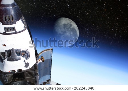 Space Shuttle orbiting the earth with moon background.\
Elements of this image furnished by NASA.