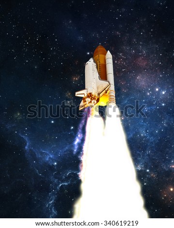 Space Shuttle launches into outer space. Elements of this image furnished by NASA.