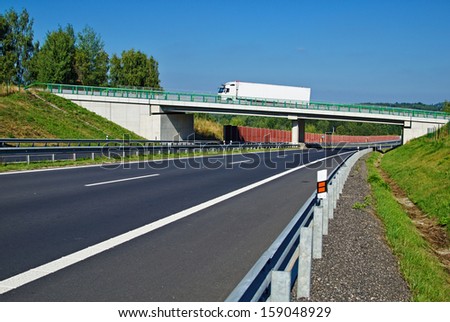 Bridge over empty highway in the countryside, the bridge rides white truck