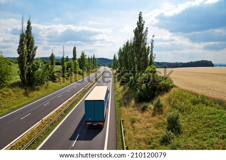 The rural landscape with a highway leading poplar alley, truck driving down the highway, view from above