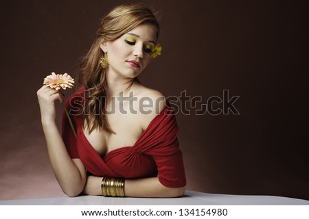 Romantic portrait of a beautiful girl on a brown background / sensual bare shoulders and neckline/colorful, spring makeup