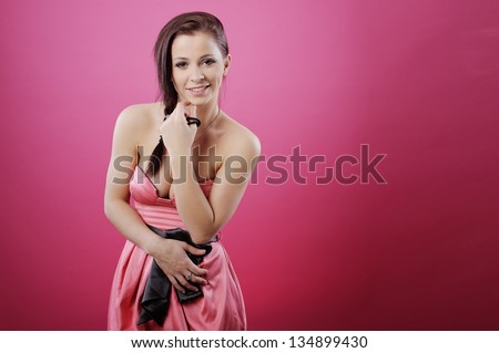 Portrait of a beautiful girl in a pink gauzy dress on light background/ Girl shows emotion, anger, anxiety, smile, joy