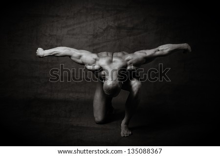 Fitness - powerful muscular man lifting weights / Muscular man with dumbbells on black background
