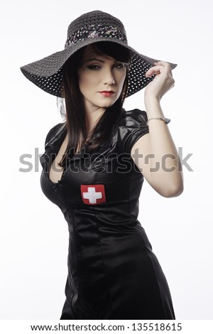 Black-haired woman in the black dress from the latex/ Sexy girlish clothes for evening wear