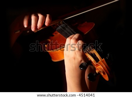 musician playing violin isolated on black