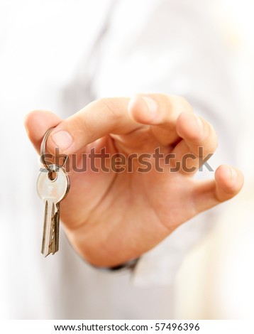 Hand holding keys. Shallow DOF, focus on keys