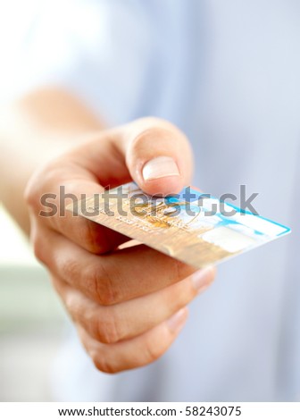 Hand with credit card. Shallow DOF