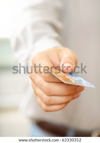 Hand with credit card. Shallow DOF