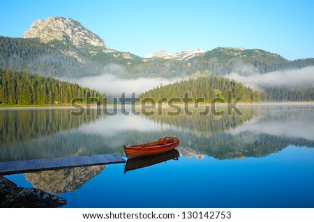 Landscape with mountains, lake and boat