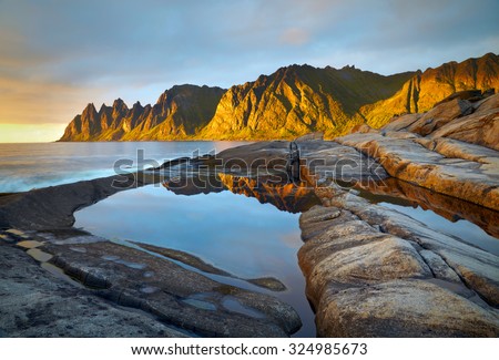 Peaks of the Okshornan mountain in sunset lights. Senja island, Norway