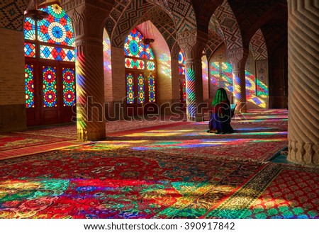Young Muslim woman praying in Nasir Al-Mulk Mosque (Pink Mosque), Iran, Shiraz