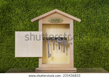 Wooden Key Holder House with  isolated white background.Property insurance and security concept .