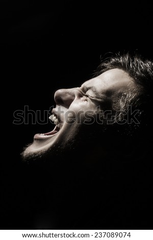 Screaming Stressed, aggressive portrait of a young student, man,.Facial expression