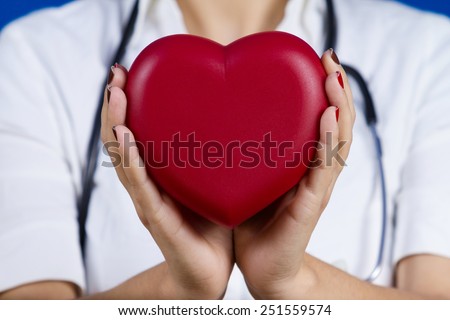 Female doctor holding red heart .Medicine,Health Care,Hospital.