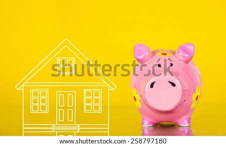 Piggy bank Real estate sale, home savings.Saving strategy. Piggy bank near a drawn house.Housing industry.