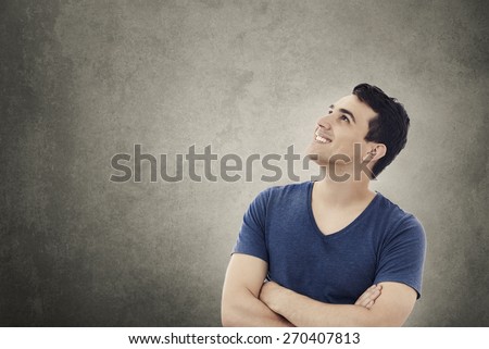 Smiling excited young man with thumb up isolated on white background.Close-up shot of Happy smiling student  with thumb up in shirt over white background.