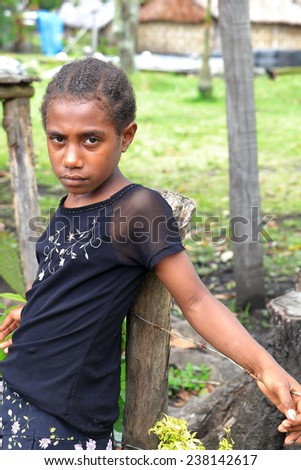 AMBRYM,VANUATU-OCTOBER 6, 2014: Sad girl buys fruit in a local store on the way home after school on October 6, in Melvert-Vanuatu.
