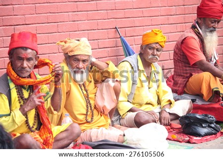 NEPAL-OCTOBER 06, 2012: Mystic Men praying with offerings in a city square on October 06, Nepal.